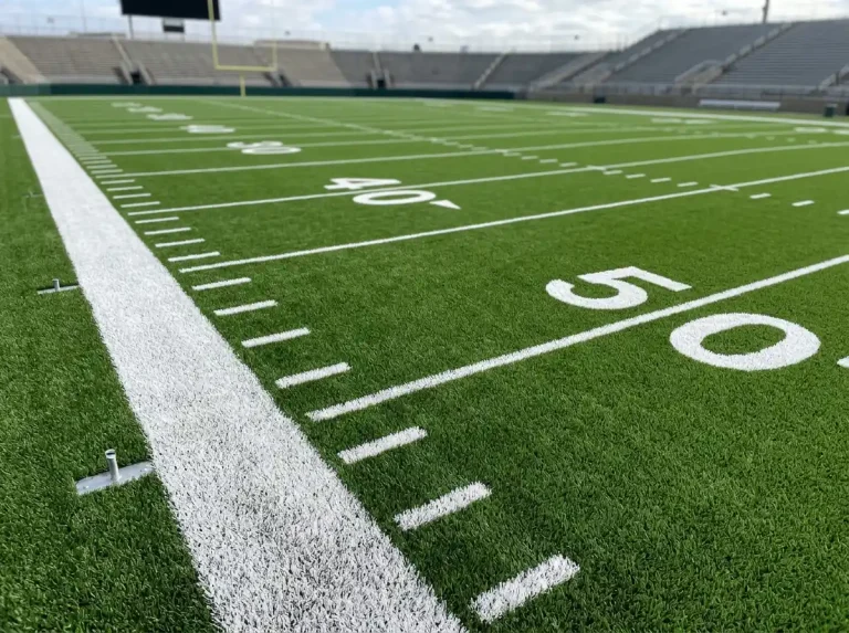 NFL gridiron field with handicap point spread numbers displayed at the sideline